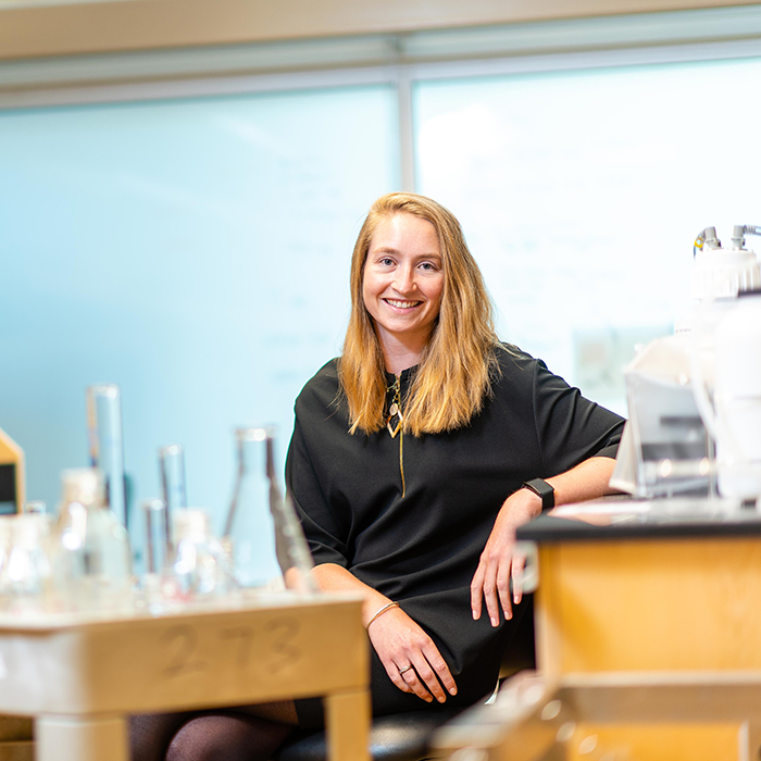 blonde woman scientist sitting in a lab