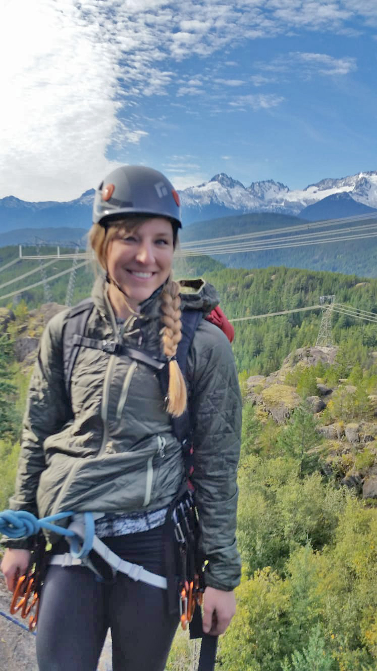 blonde woman in a climbing harness