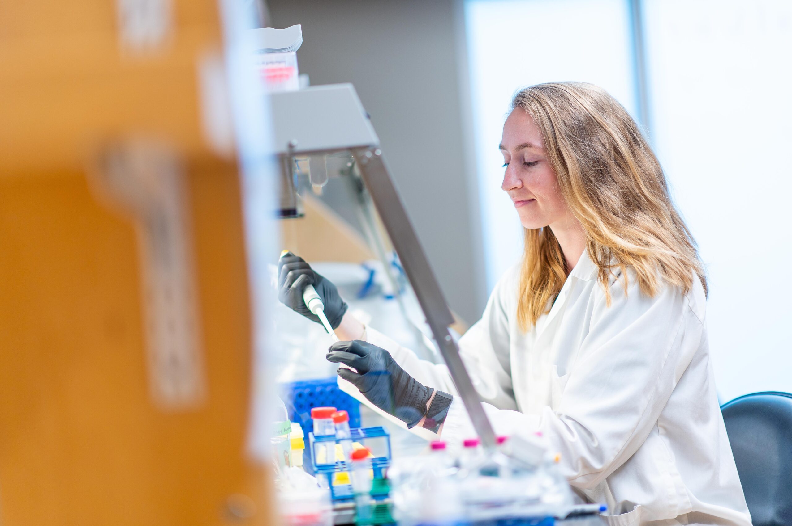 blond female scientist working at a lab bench