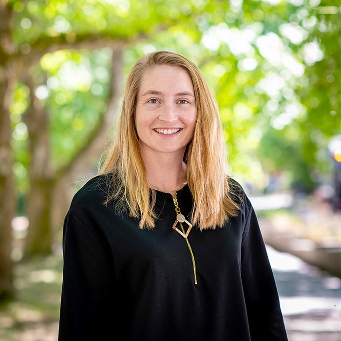 Dr. Anna Blakney standing in front of trees outside