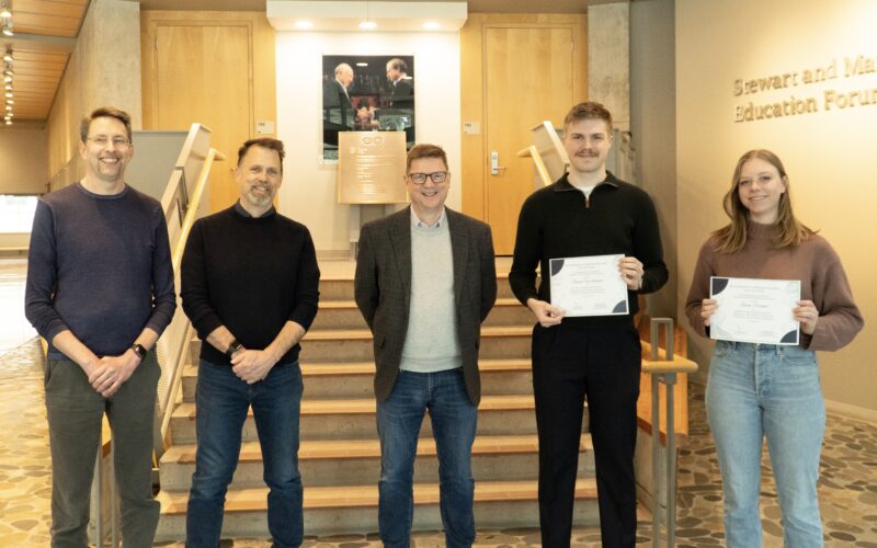 MBIM Department Head Dr. Michael Murphy, MSL Director Dr. Martin Hirst, Zymeworks Chief Scientific Officer Dr. Paul Moore, and recipients Thomas Worthington and Lauren Durland pose smiling after the presentation of the Zymeworks Fellowship award certificates.