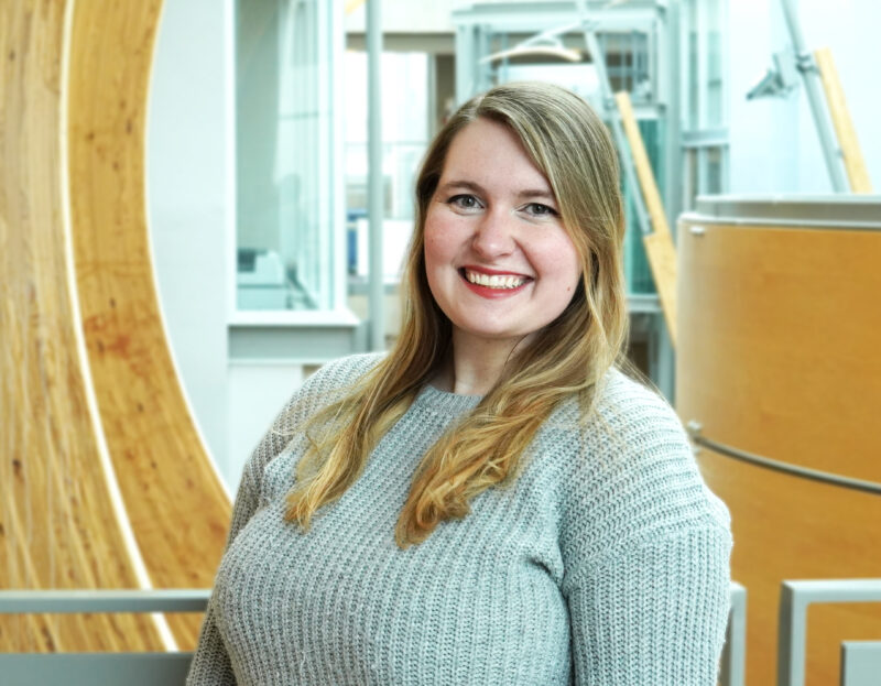 Marie Johns, smiling at the camera, in the Michael Smith Laboratories building.