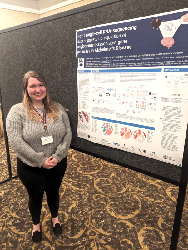 Marie Johns stands smiling next to a poster that reads "Novel single-cell RNA-sequencing data suggests upregulation of angiogenesis-associated gene pathways in Alzheimer's Disease".